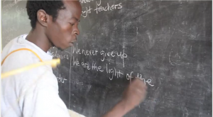 Man writes at a blackboard