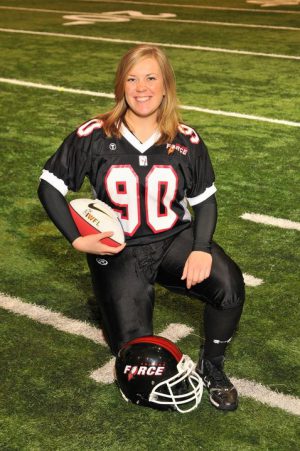 Women's Football Champion Liz Okey kneels