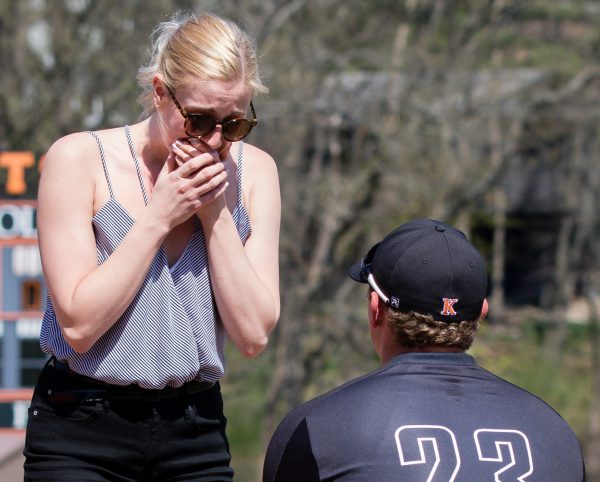 Connor Grant on one knee in front of Kelsey Corless for surprise proposal