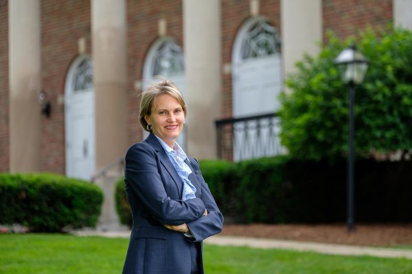 Laura Lowe Furge, one of five endowed chairs, stands outside Stetson Chapel