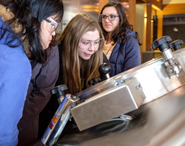 Students look inside kettles at Bell’s Brewery tour