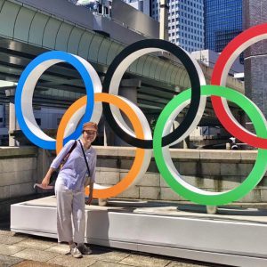 Uyen Trinh standing next to the Olympic rings_fb