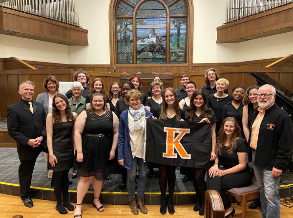 A group of College Singers performers with a K flag