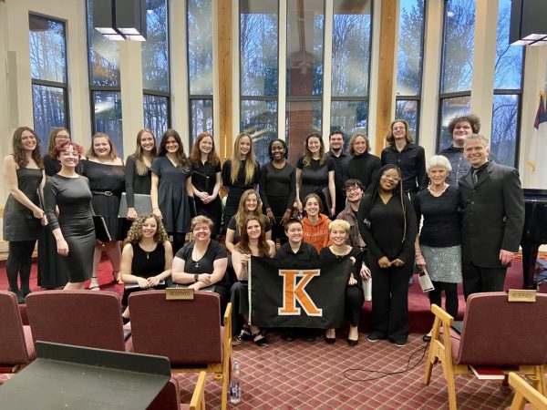 A group of College Singers performers with a K flag