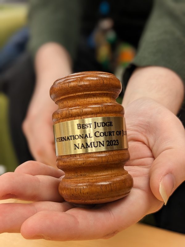 Thomas Lichtenberg holds a gavel awarded to the Best Judge at the North American Model United Nations Conference