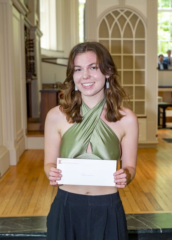 Student poses with senior award