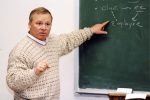 Professor Timothy Moffitt teaches a class from a blackboard