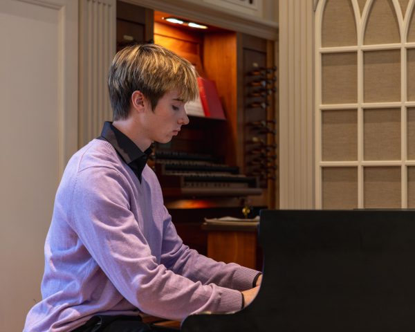 Teige Bredin performs at a piano