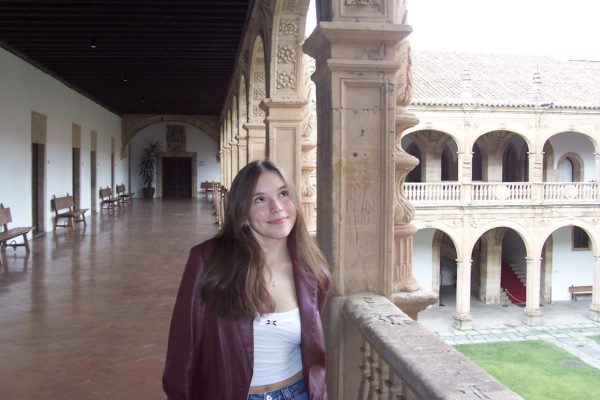 Ella MIller '26 stands in the historic inner courtyard of the Colegio Arzobispo Fonseca in Salamanca, Spain, during her study abroad experience