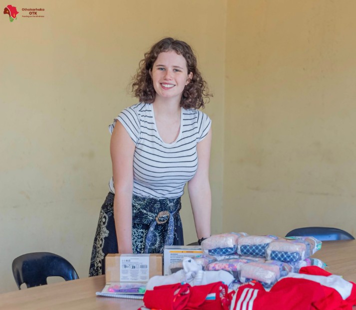 Woman standing next to a table filled with supplies