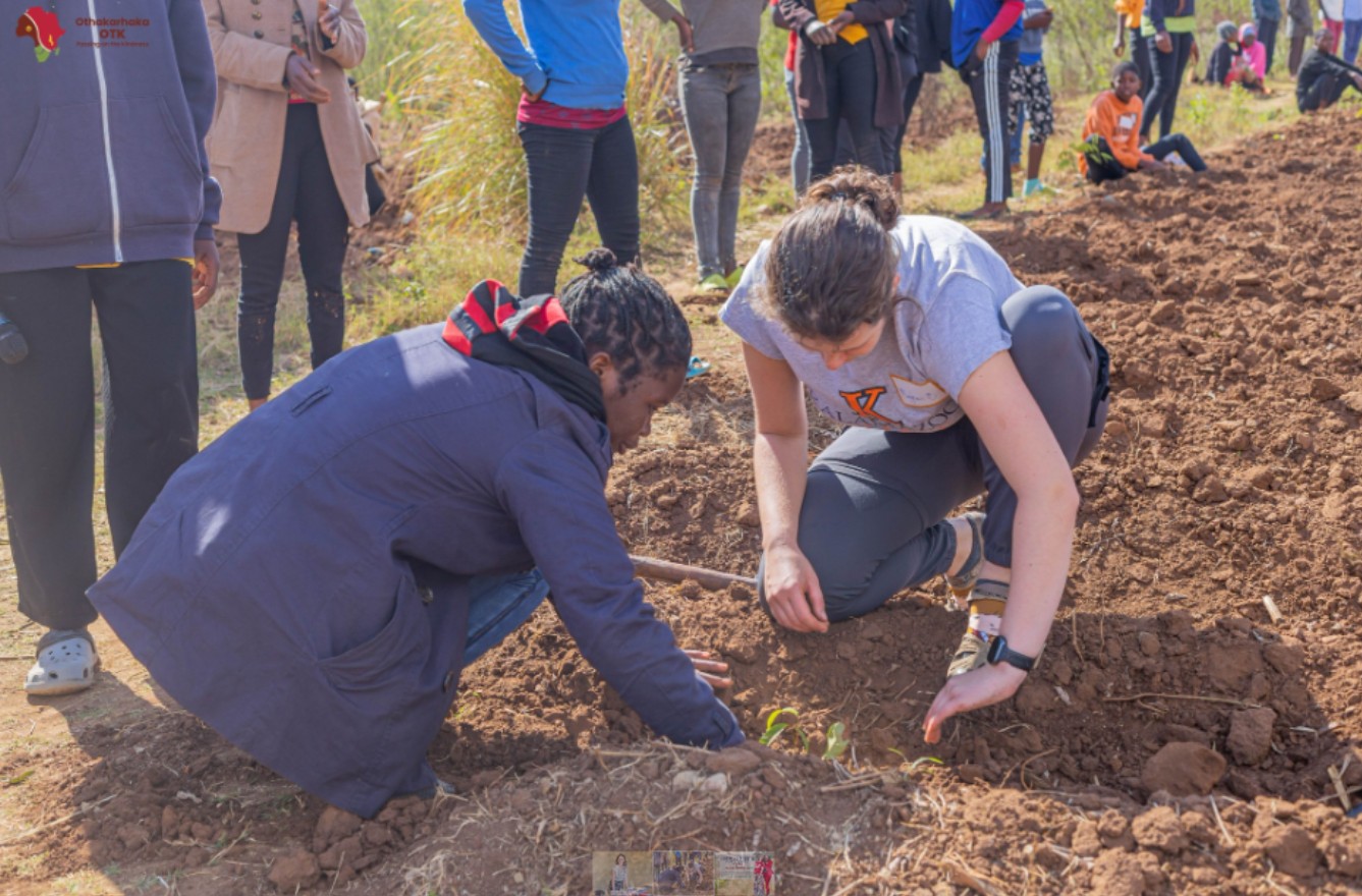 Two women planting a tree
