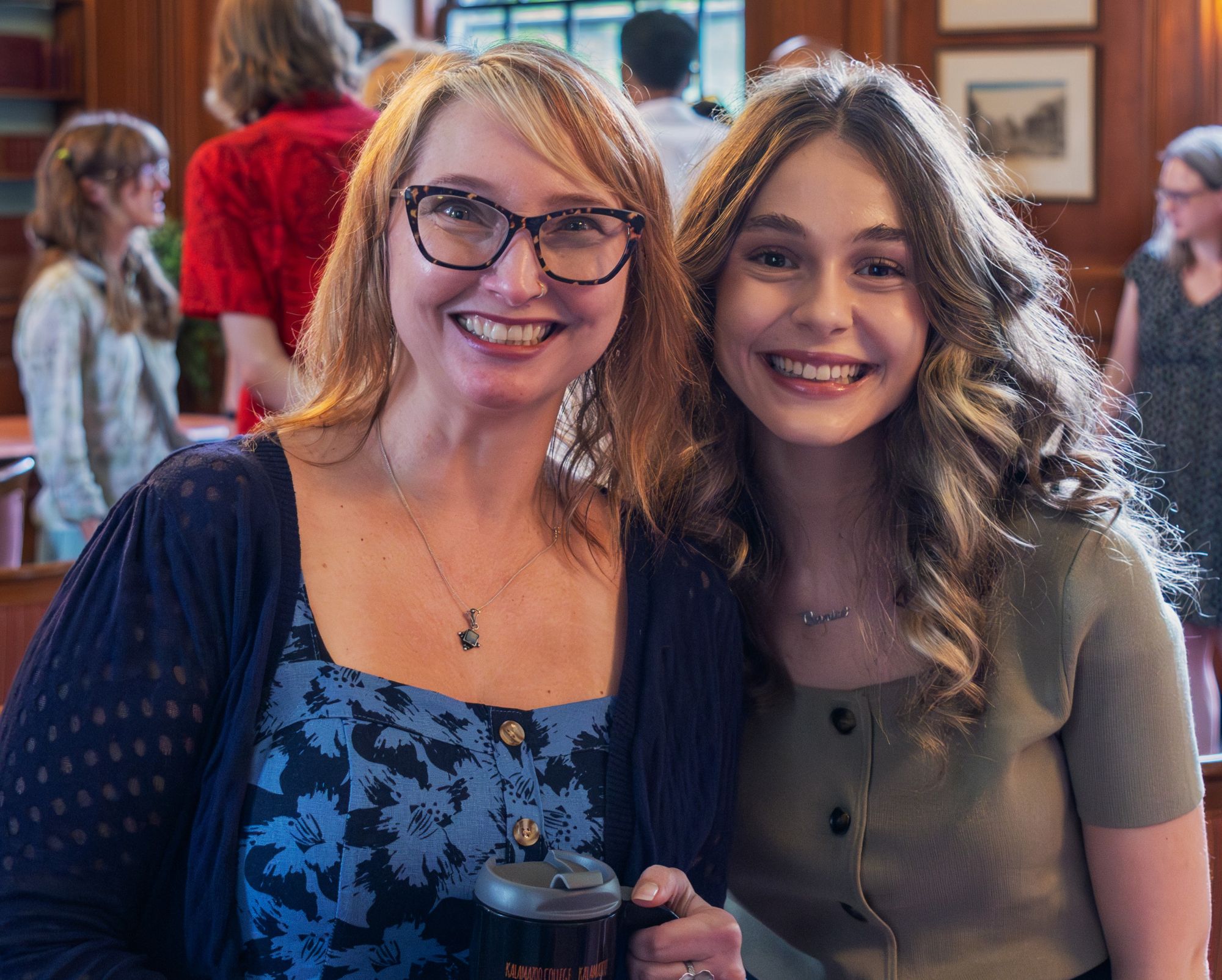 Staff member and student smile during ceremony