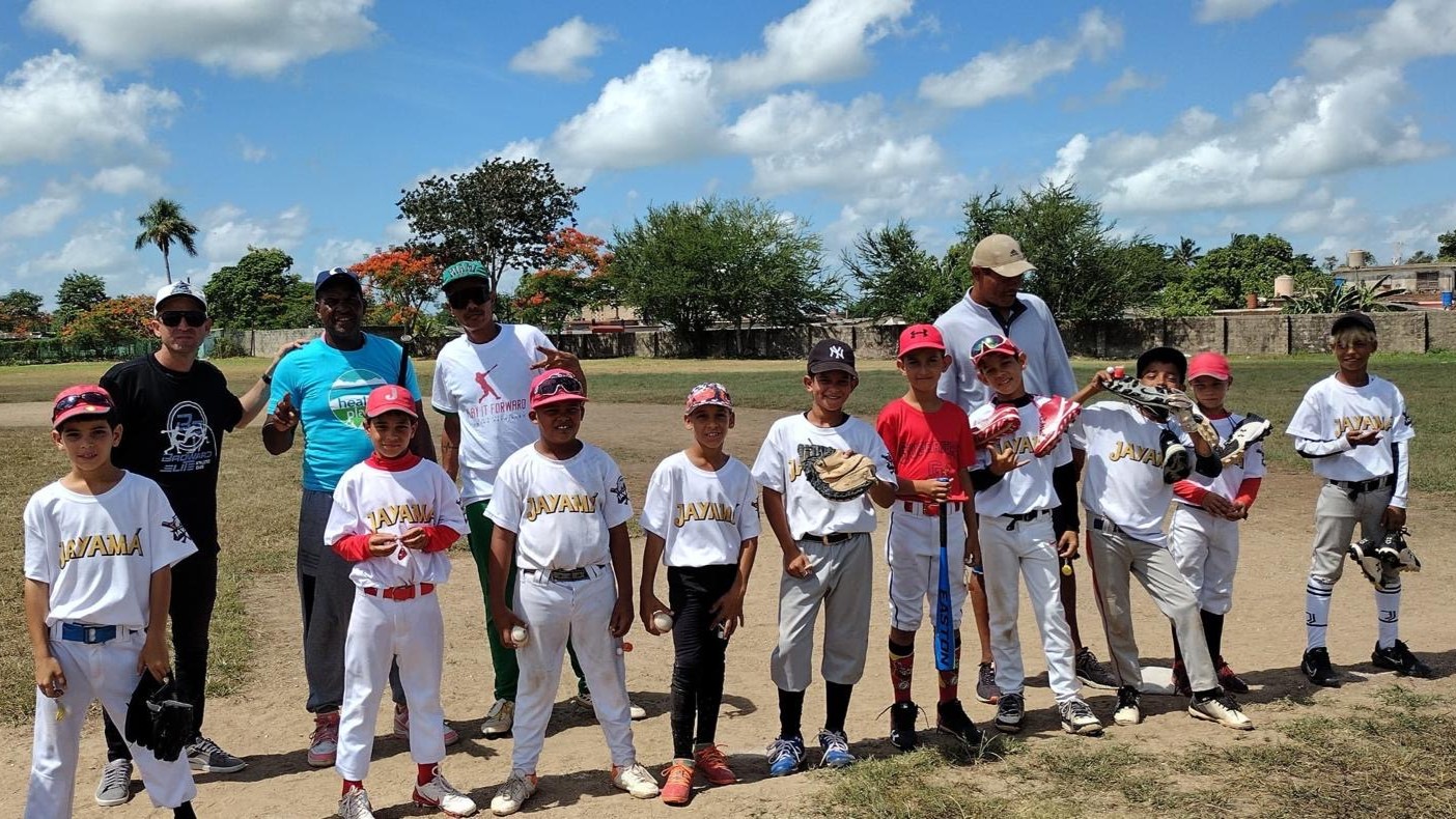 A young team of baseball players in Cuba shows off equipment provided by Play it Forward