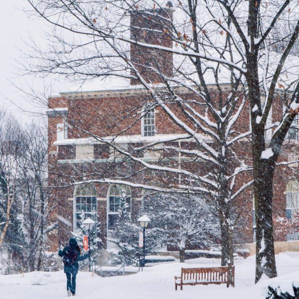 Winter scene with Mandelle Hall and person walking