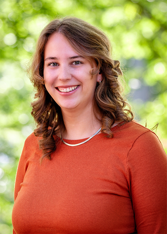 Headshot of Laurel Palmer Director, Kalamazoo College Fund. A blurred natural setting is visible behind her.