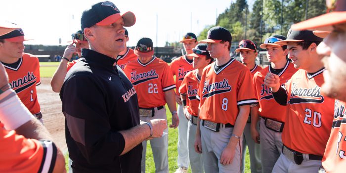 Baseball team huddle with coach