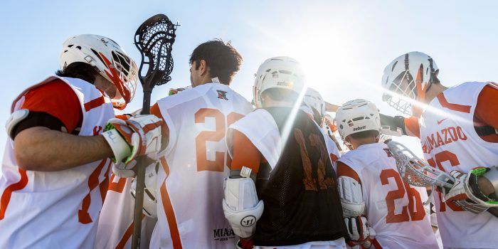 male lacrosse team huddle