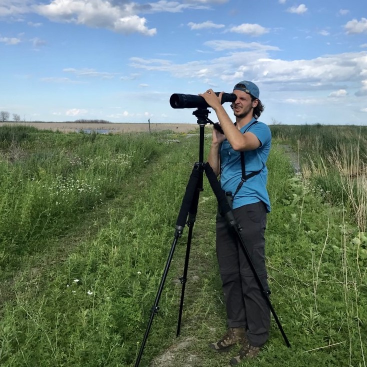 Will Keller '23 taking photos of birds in a field
