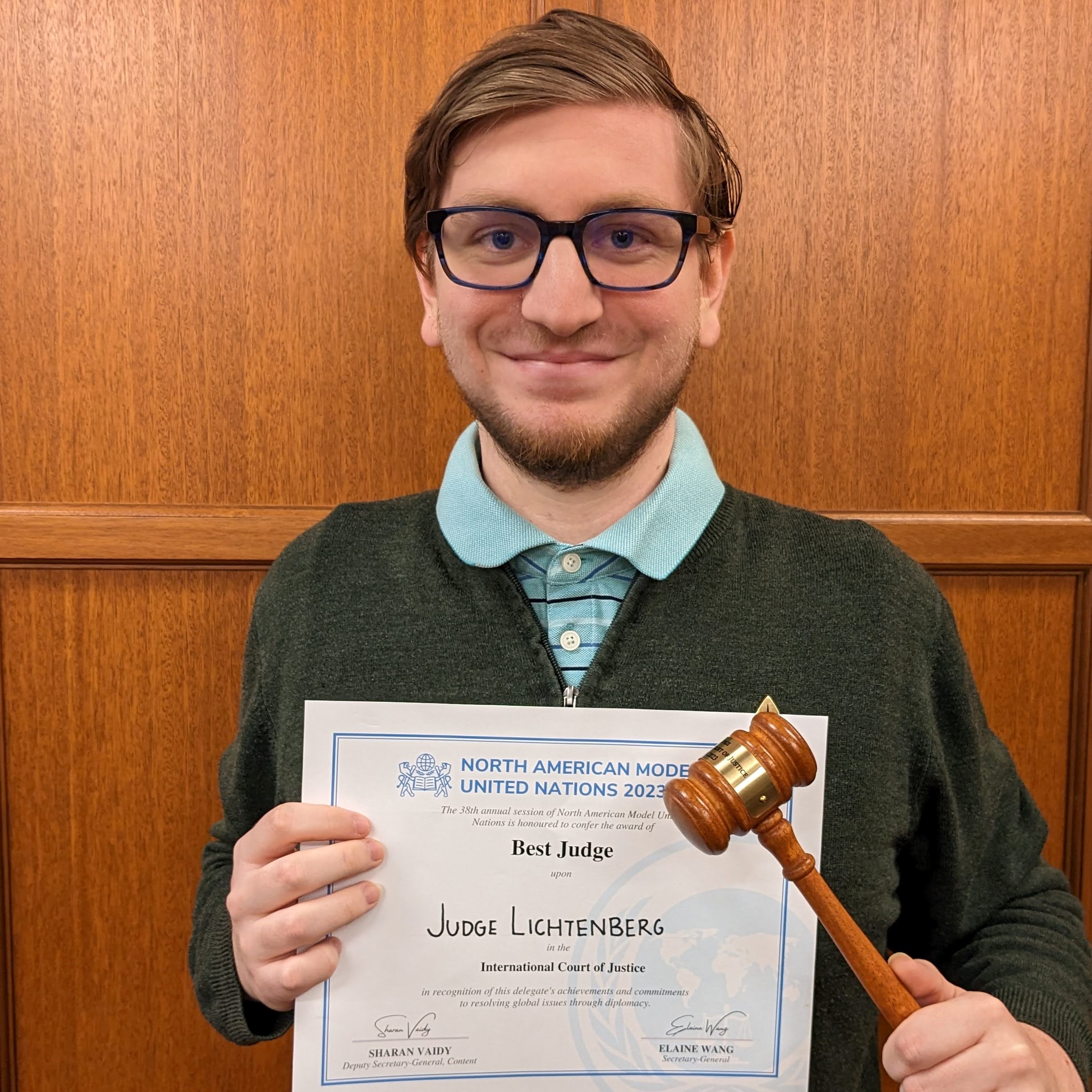 Thomas Lichtenberg holding a gavel and best judge certificate