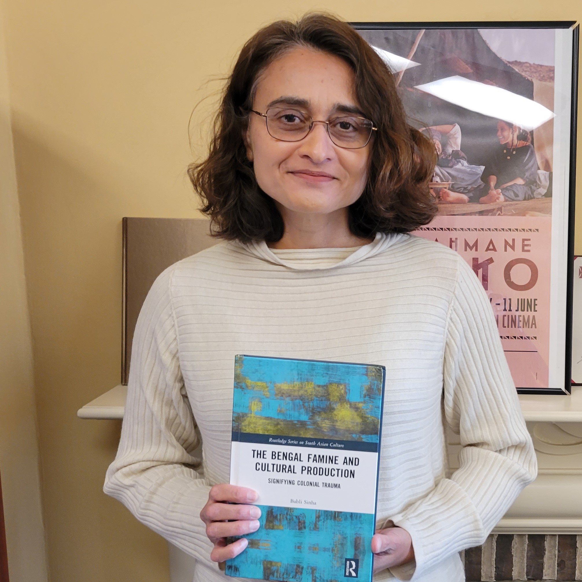 English Professor Babli Sinha holding her bookl