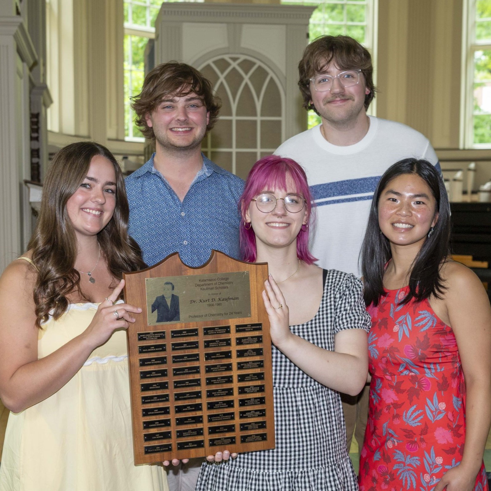 Five seniors accepting a plaque