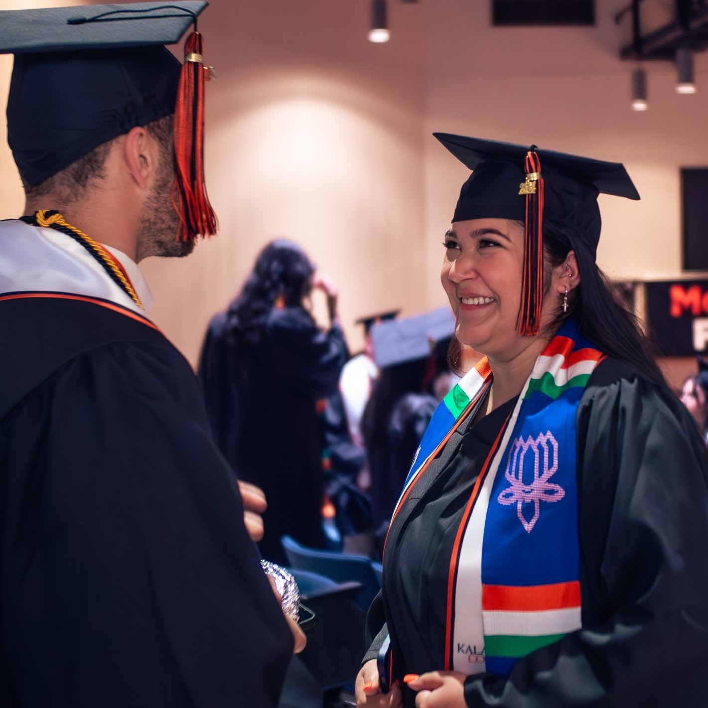 Two graduates at Commencement