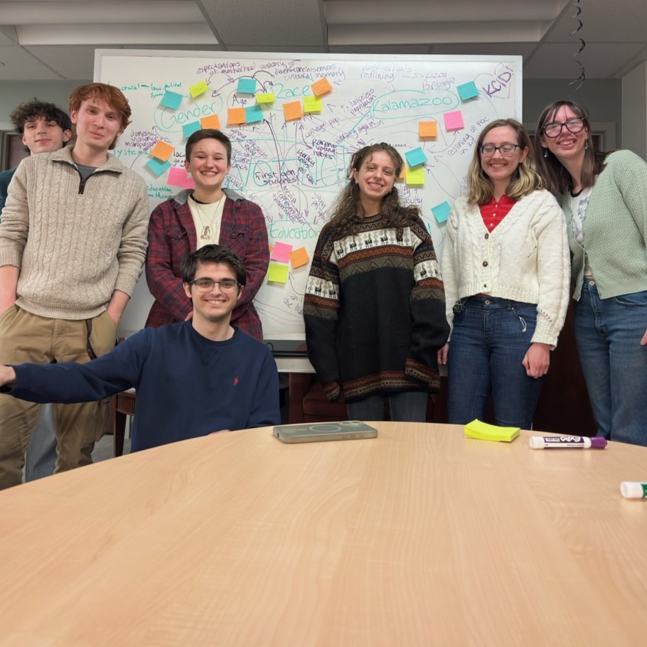 K Votes volunteers in front of a well-marked dry-erase board.