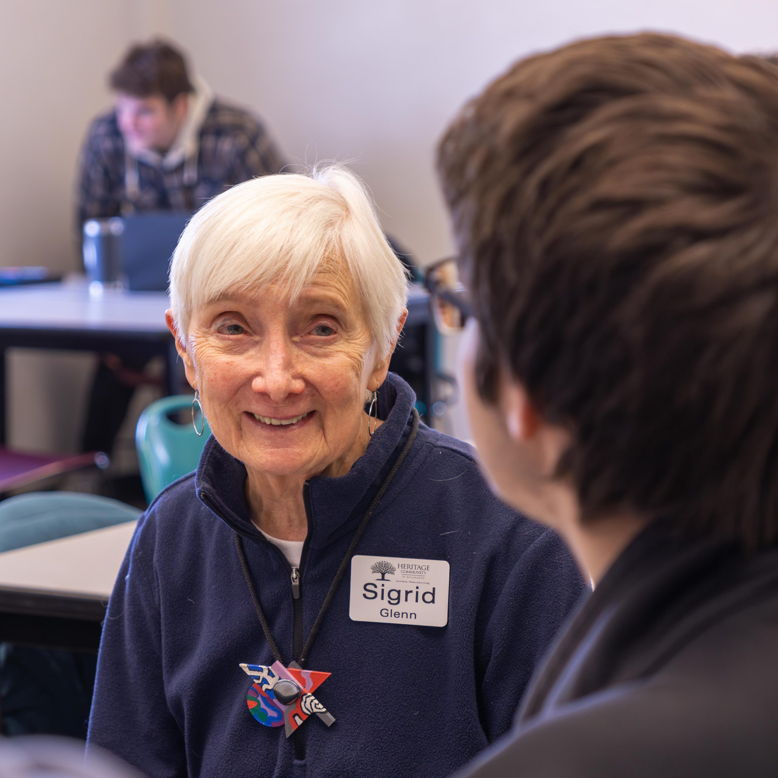 Senior and student work together in Principles of Marketing class.