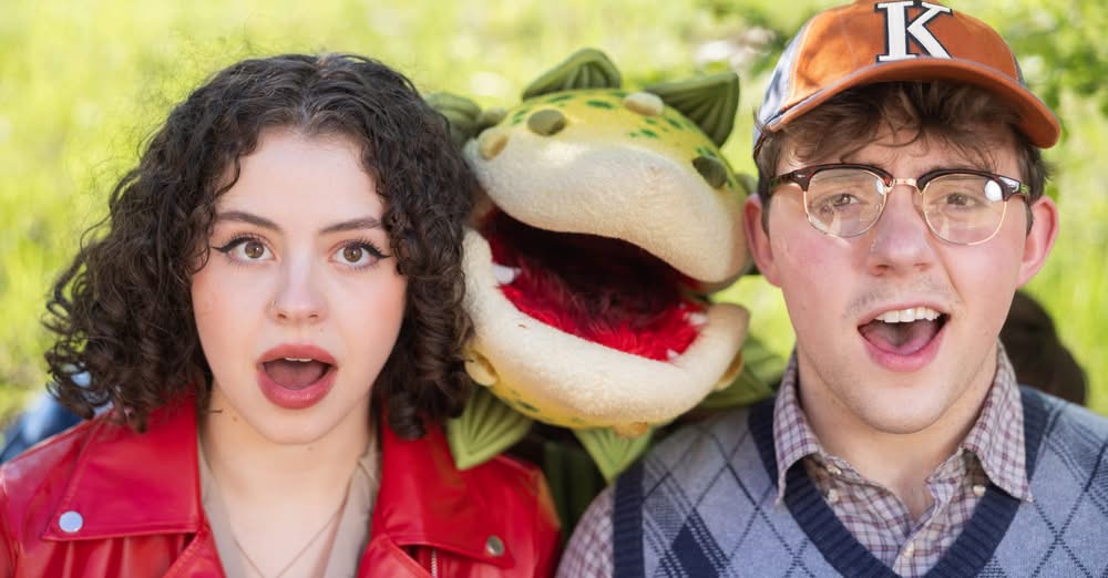 A girl and guy with an alien plant for Little Shop of Horrors