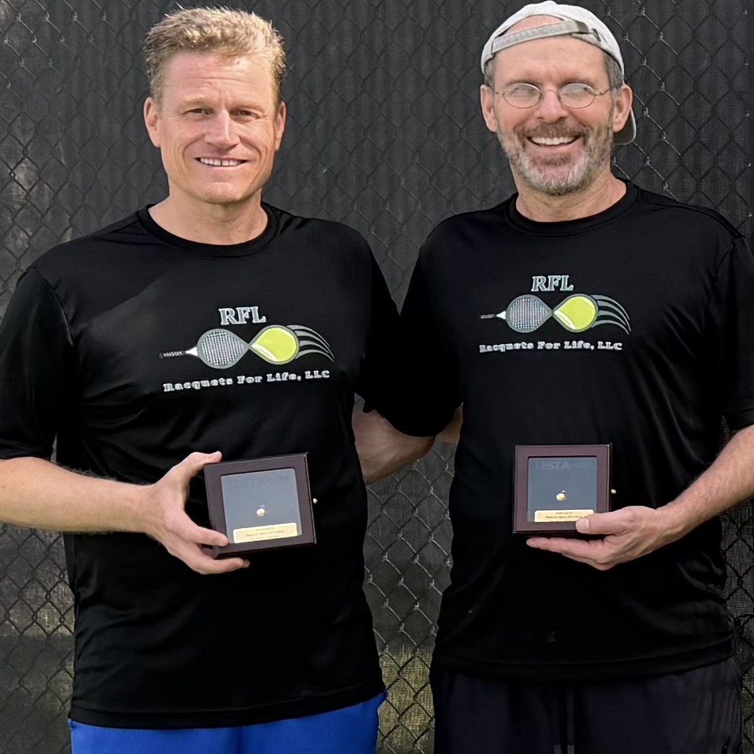 Tennis players pose with their trophies